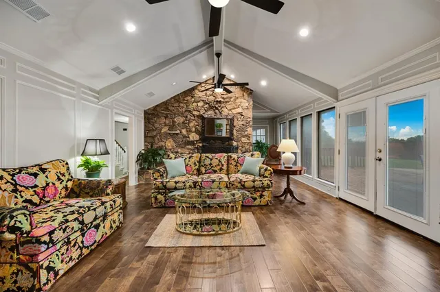 a living room with furniture and a chandelier