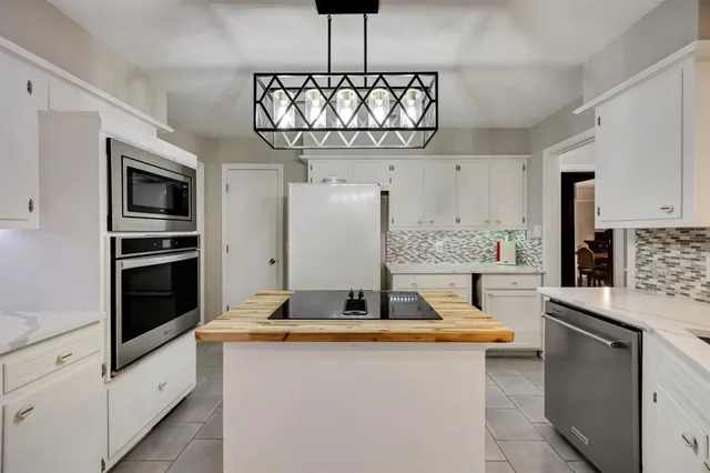 a kitchen with stainless steel appliances granite countertop a sink and cabinets