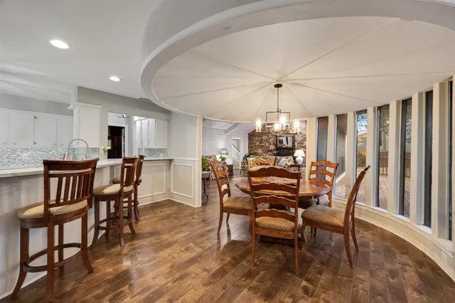 a dining room with furniture window and wooden floor