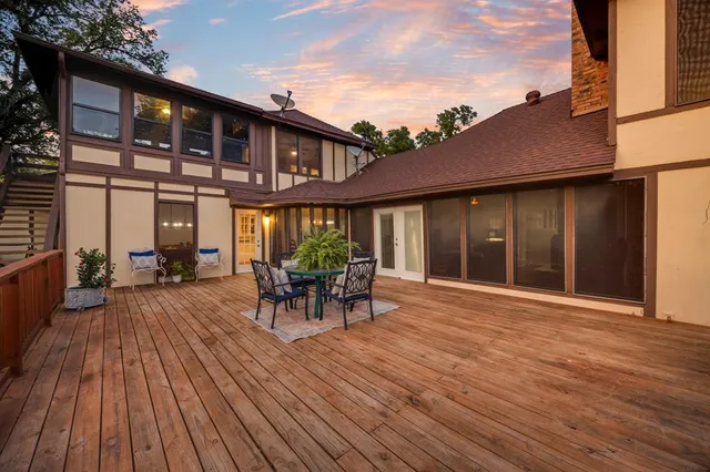 a view of a house with a big yard and large trees
