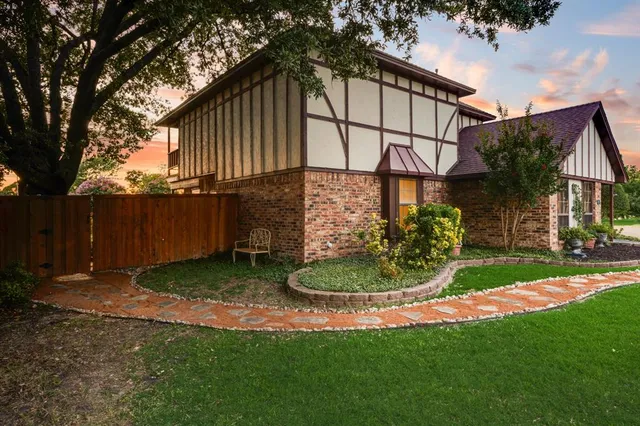 a backyard of a house with a garden and barbeque oven