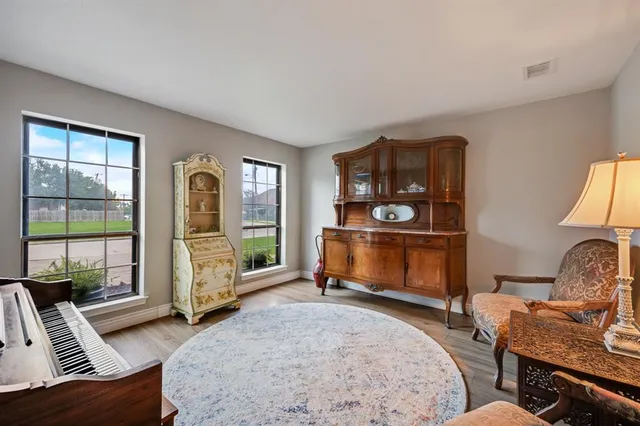 a living room with furniture a window and a flat screen tv
