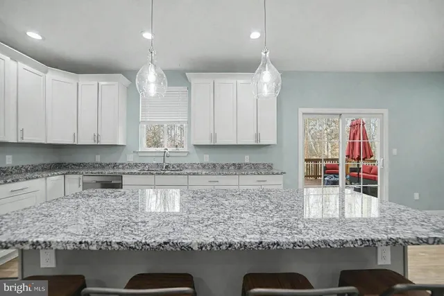 a kitchen with stainless steel appliances granite countertop a sink stove and cabinets