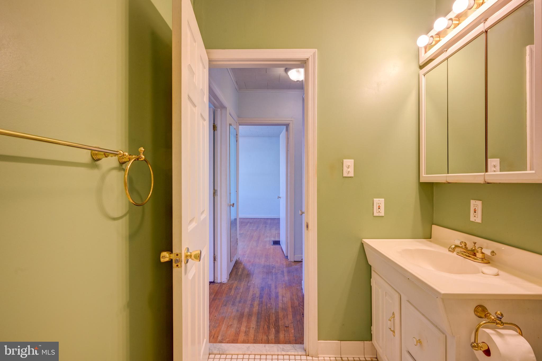 5630 Oakland Road Baltimore, MD 21227 - Photo 19 of 31 a bathroom with a sink and a mirror