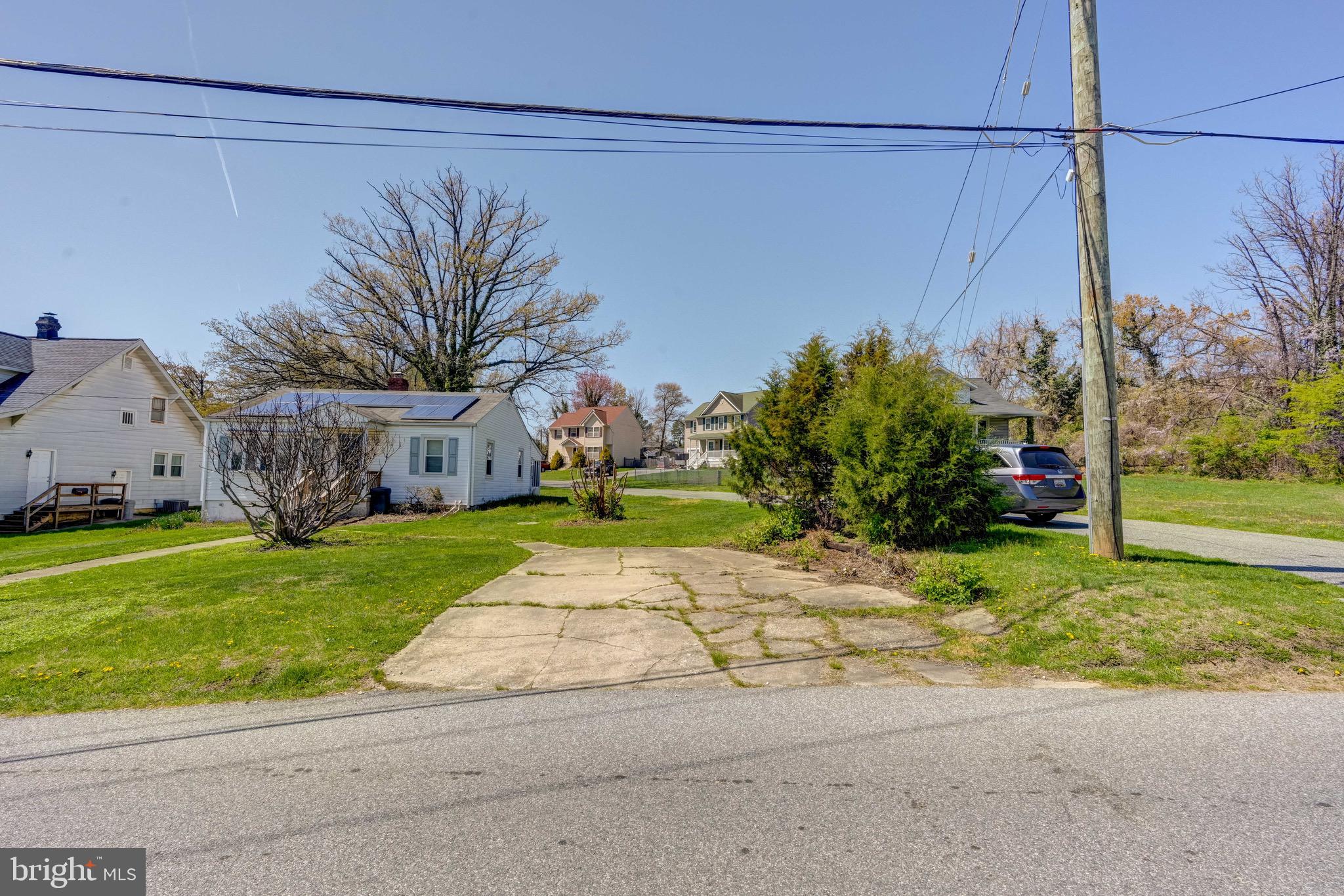 5630 Oakland Road Baltimore, MD 21227 - Photo 29 of 31 a view of a house with a yard and a garden