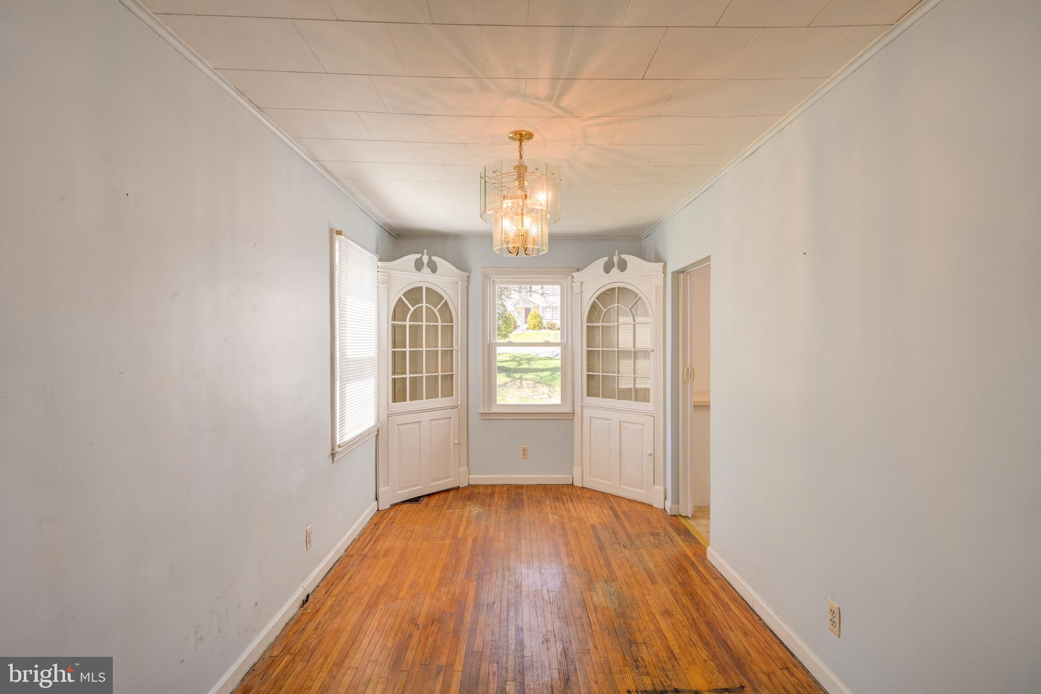 5630 Oakland Road Baltimore, MD 21227 - Photo 6 of 31 a view of empty room with wooden floor and window