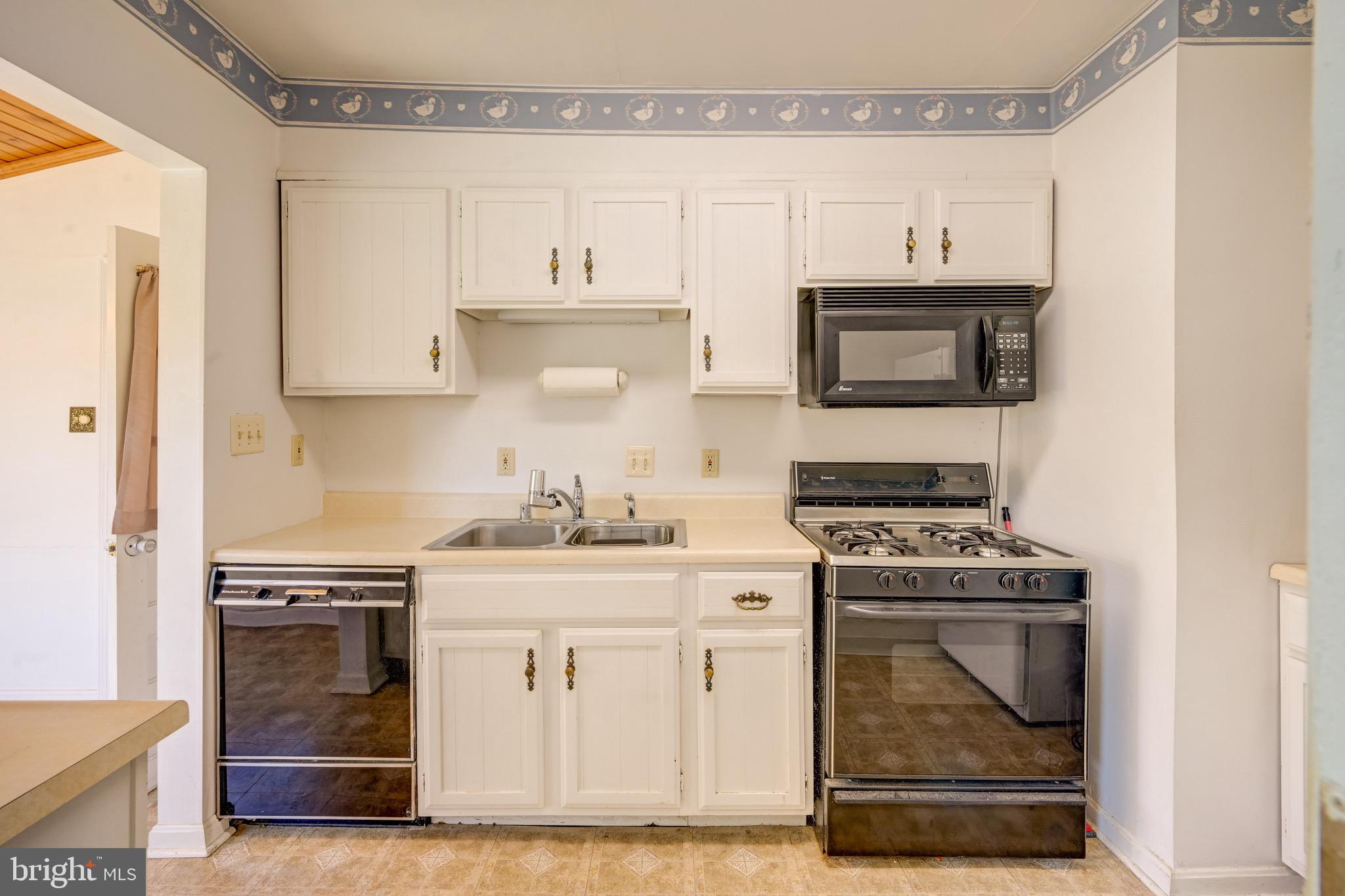 5630 Oakland Road Baltimore, MD 21227 - Photo 8 of 31 a kitchen with cabinets appliances and a sink
