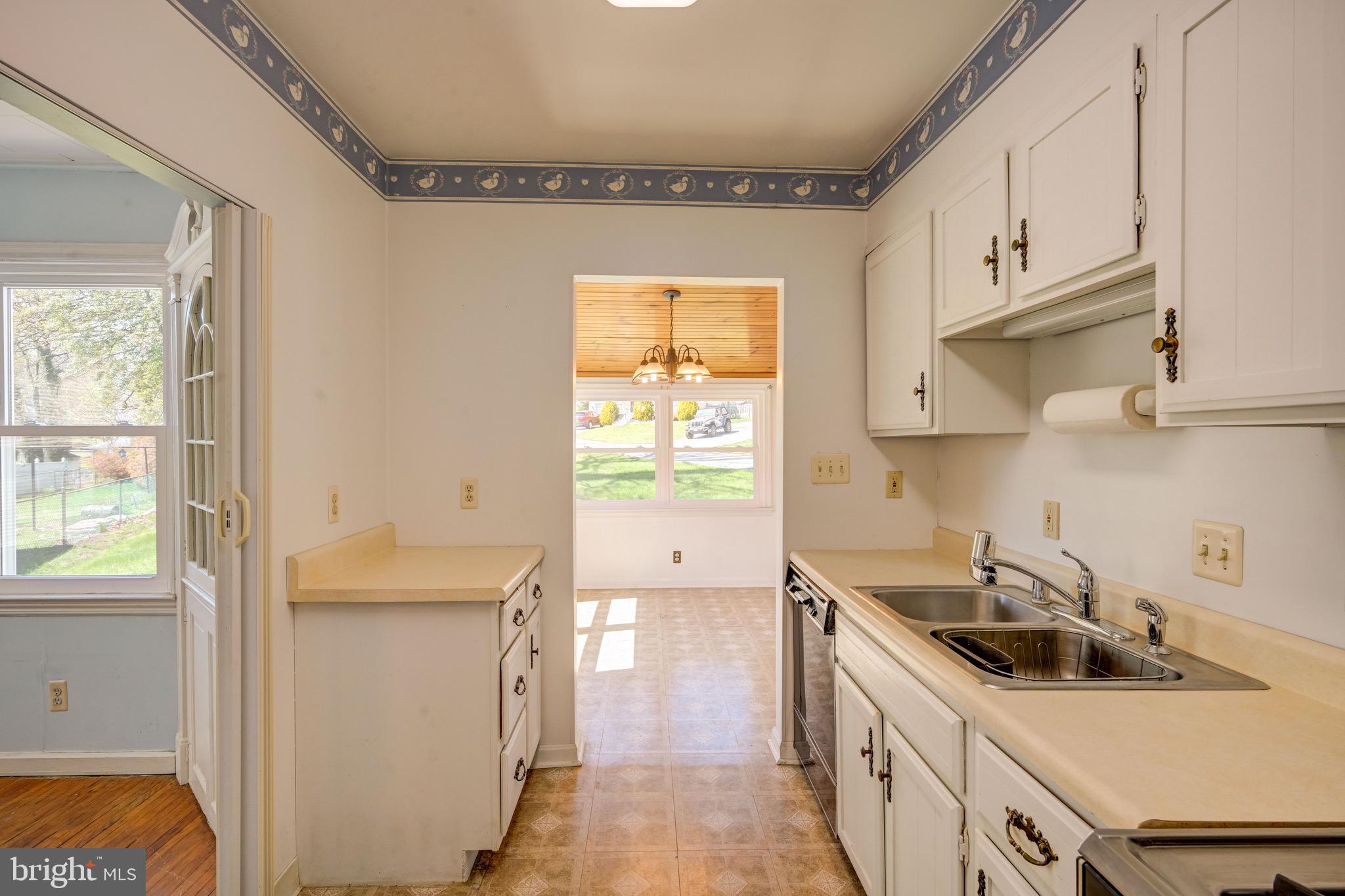 5630 Oakland Road Baltimore, MD 21227 - Photo 9 of 31 a kitchen that has a sink a stove and window
