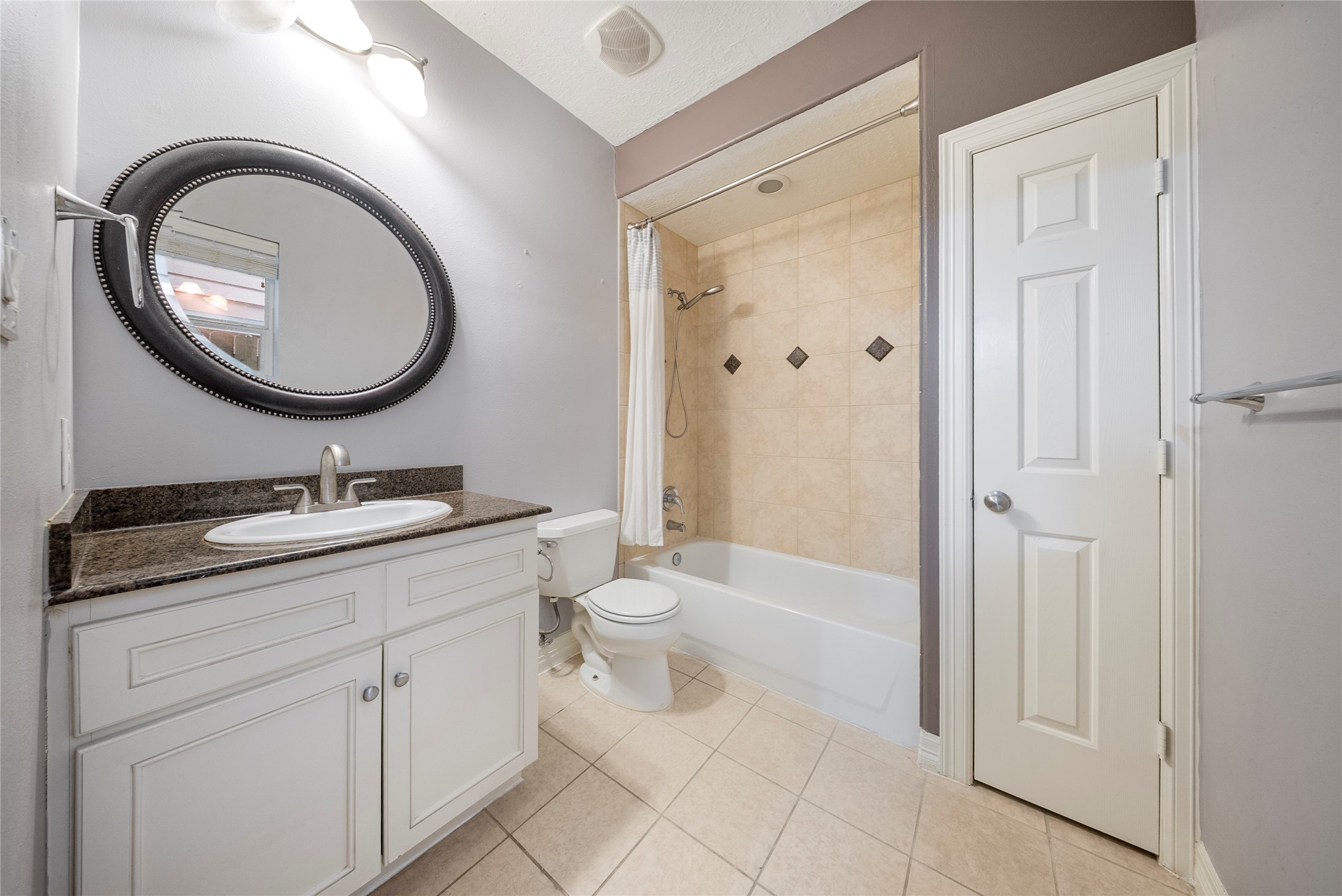 4216 Eli Street Houston, TX 77007 - Photo 18 of 19 a bathroom with a toilet a sink and a mirror