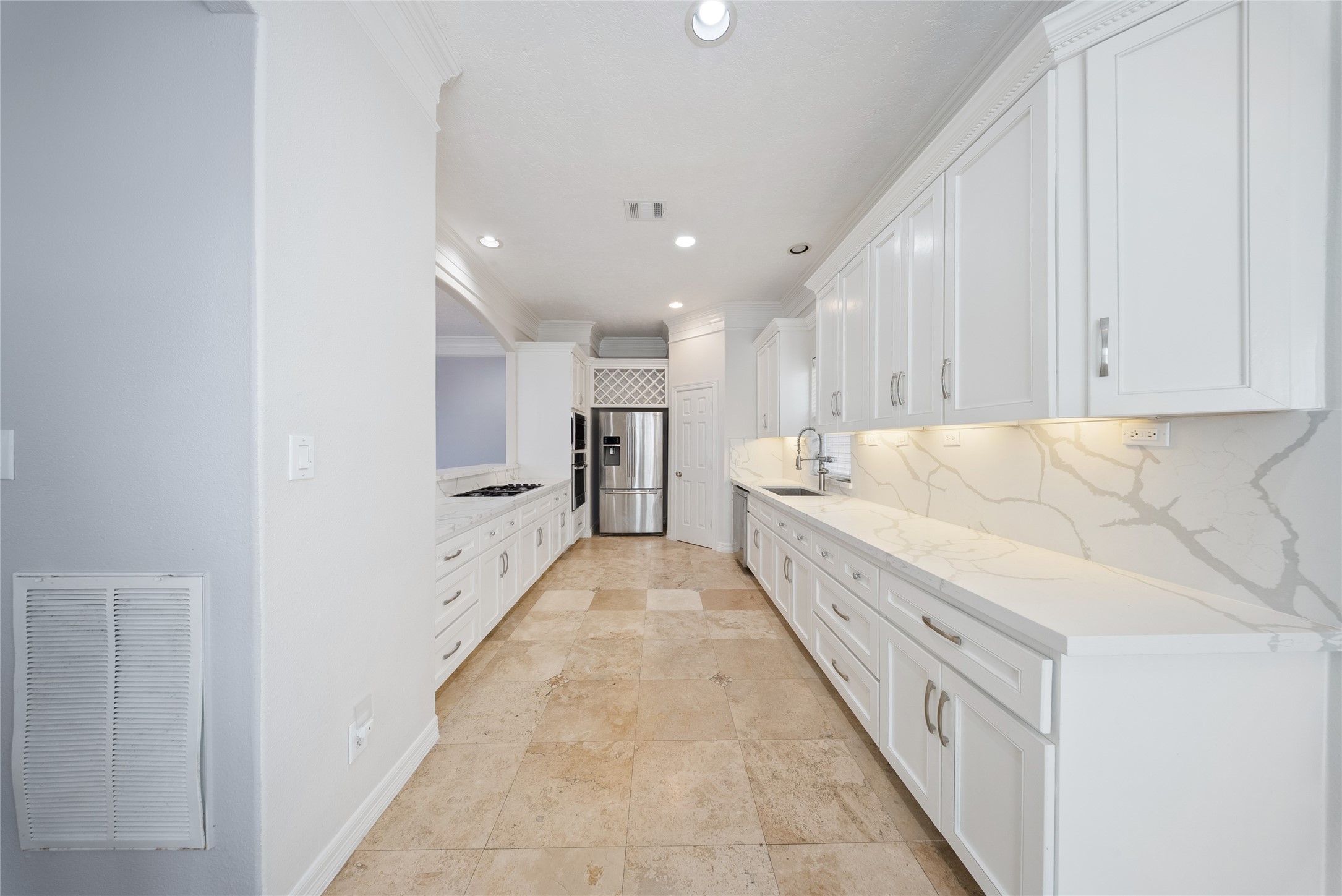 4216 Eli Street Houston, TX 77007 - Photo 2 of 19 a large white kitchen with center island and stainless steel appliances