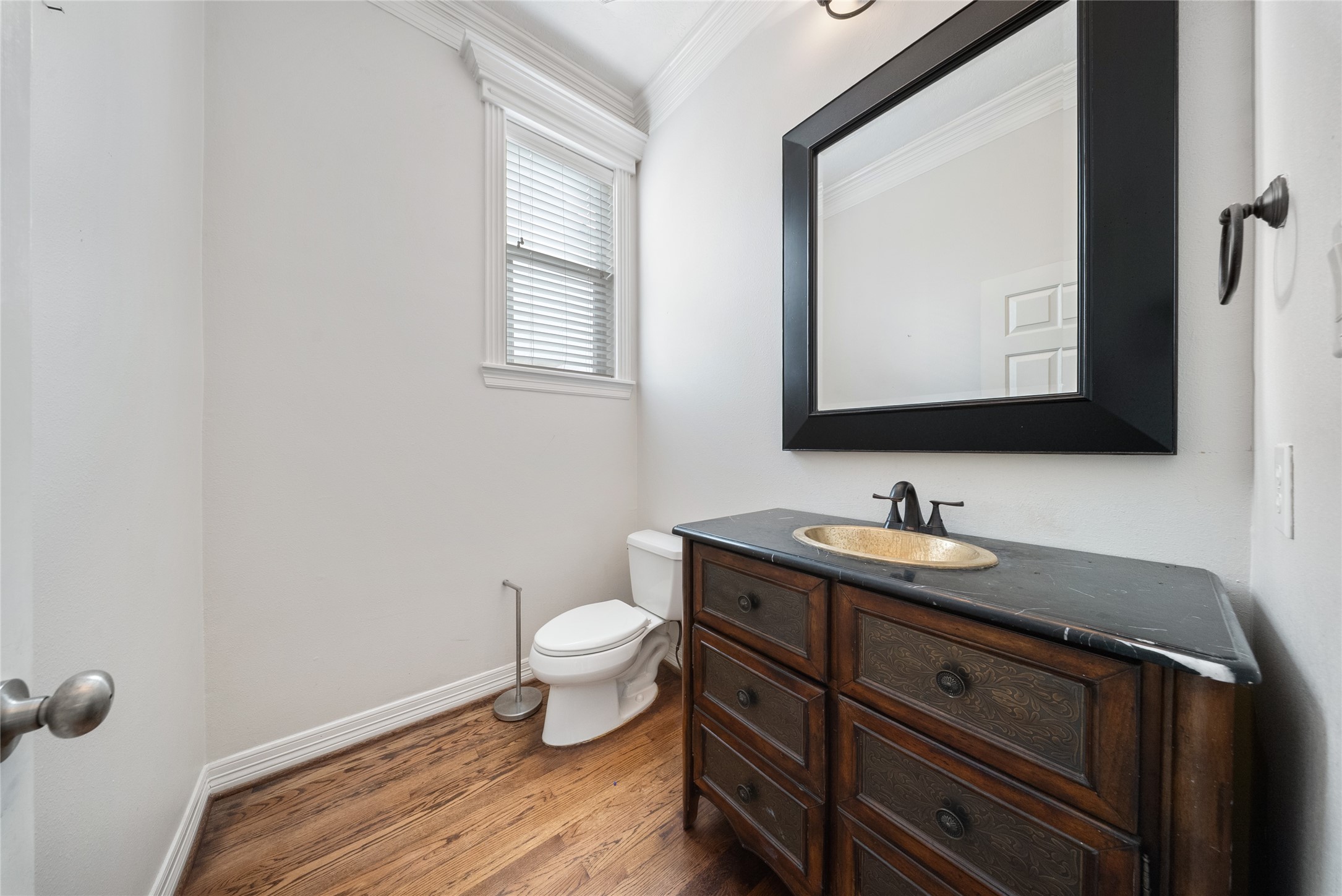 4216 Eli Street Houston, TX 77007 - Photo 7 of 19 a bathroom with a toilet sink and mirror