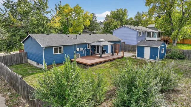 a aerial view of a house with a yard table and chairs