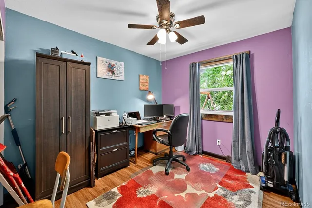 a view of a workspace with furniture and a window
