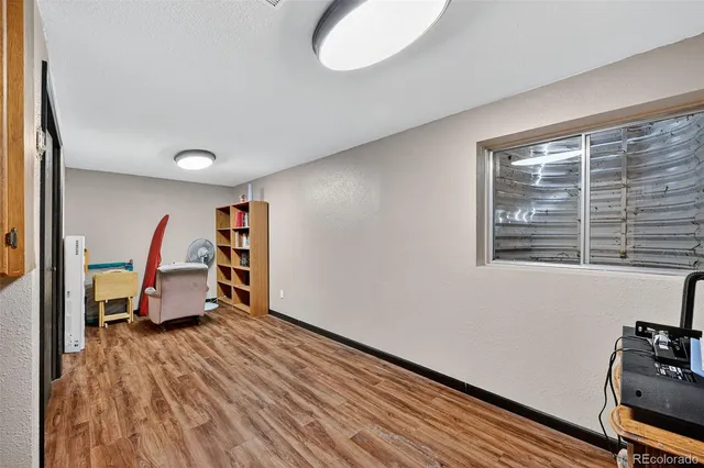 a room with wooden floor and a window