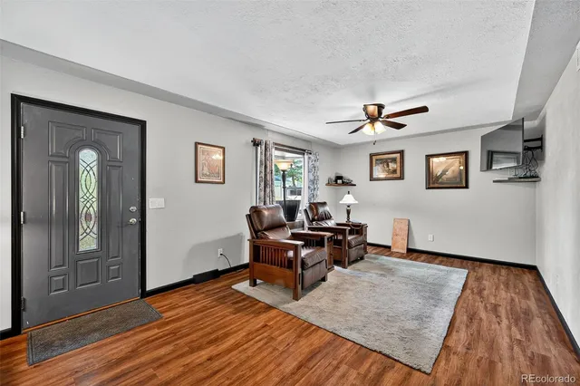 a living room with furniture and wooden floor