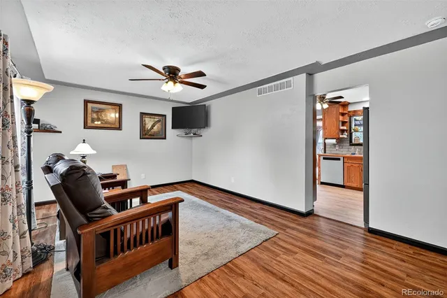 a bedroom with furniture and wooden floor