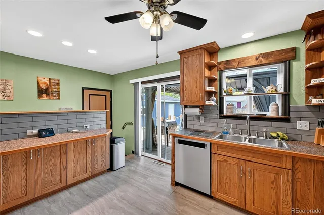 a kitchen with stainless steel appliances granite countertop a sink and wooden cabinets