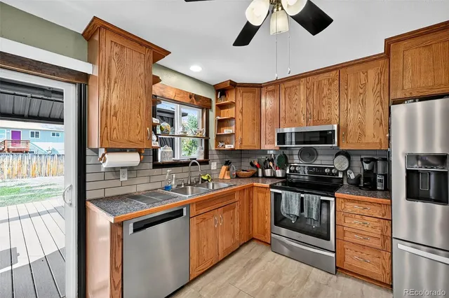 a kitchen with stainless steel appliances granite countertop a stove sink and refrigerator