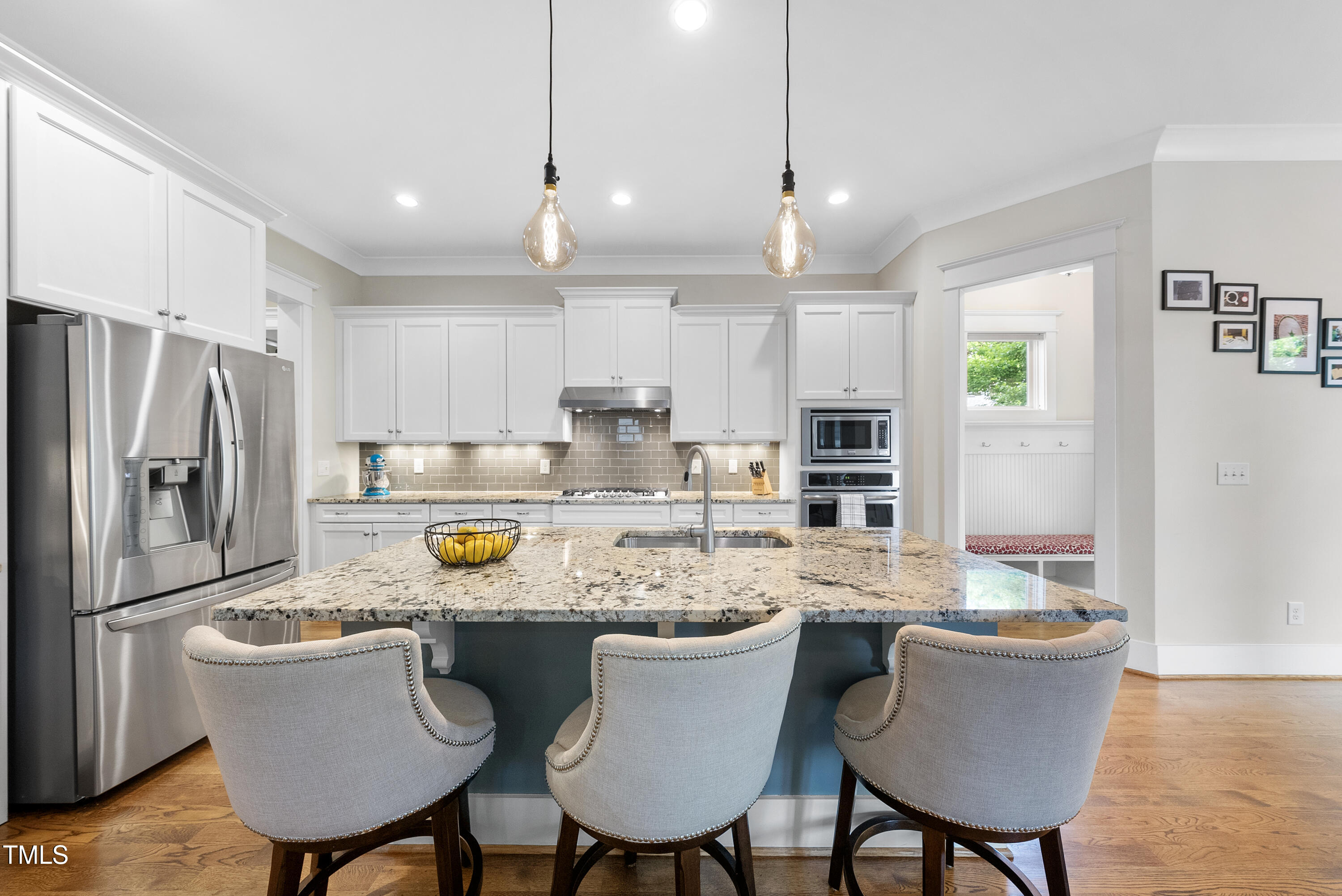 707 Sasser Street Raleigh, NC 27604 - Photo 7 of 38 a kitchen with a dining table chairs refrigerator and cabinets
