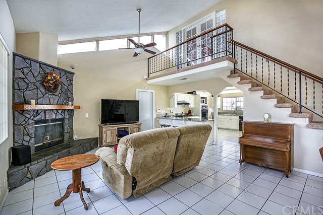 16304 Sago Road Apple Valley, CA 92307 - Photo 1 of 1 a living room with furniture a flat screen tv and a fireplace