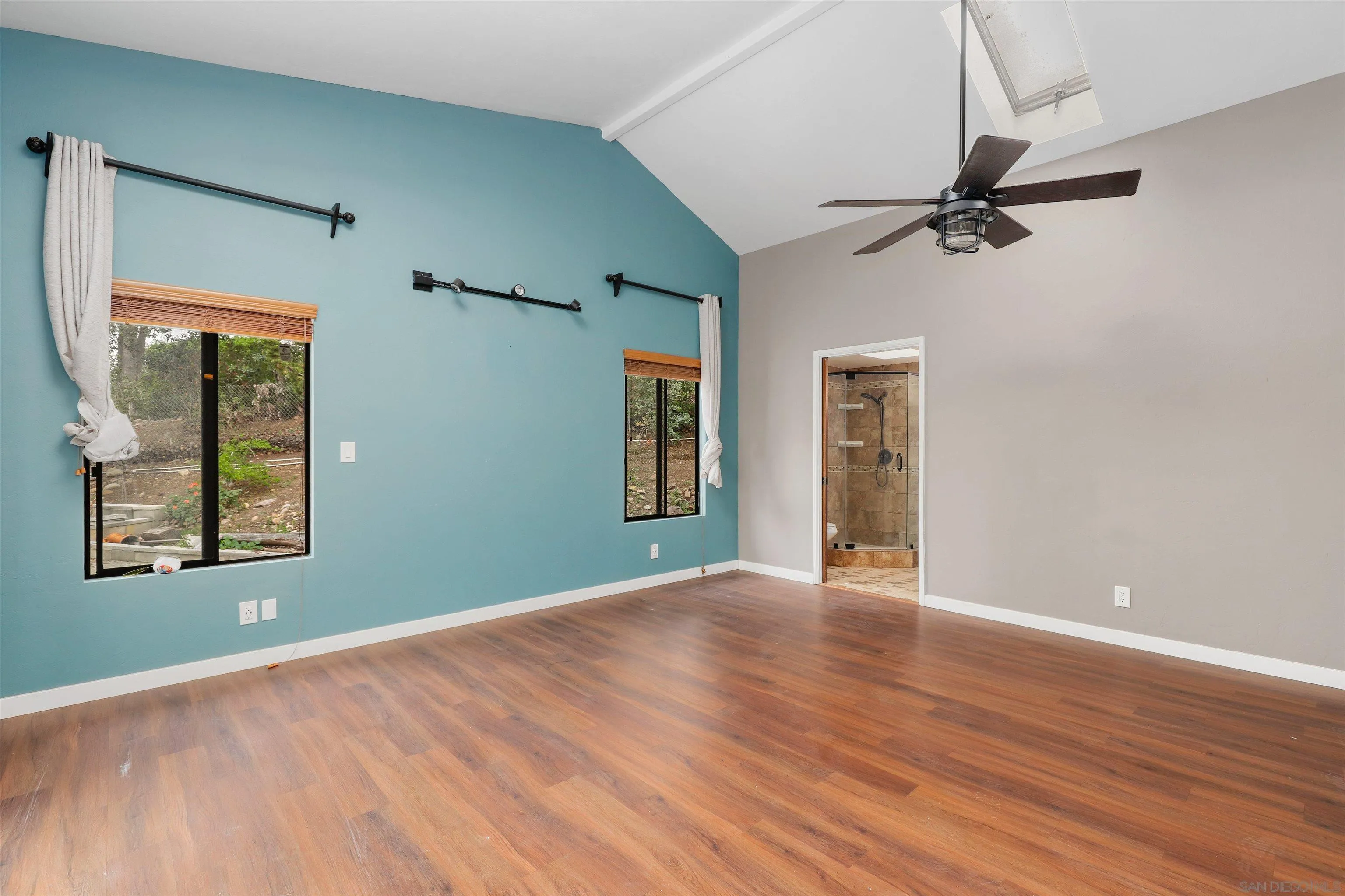12256 Old Stone Road Poway, CA 92064 - Photo 19 of 31 an empty room with wooden floor cabinet and windows