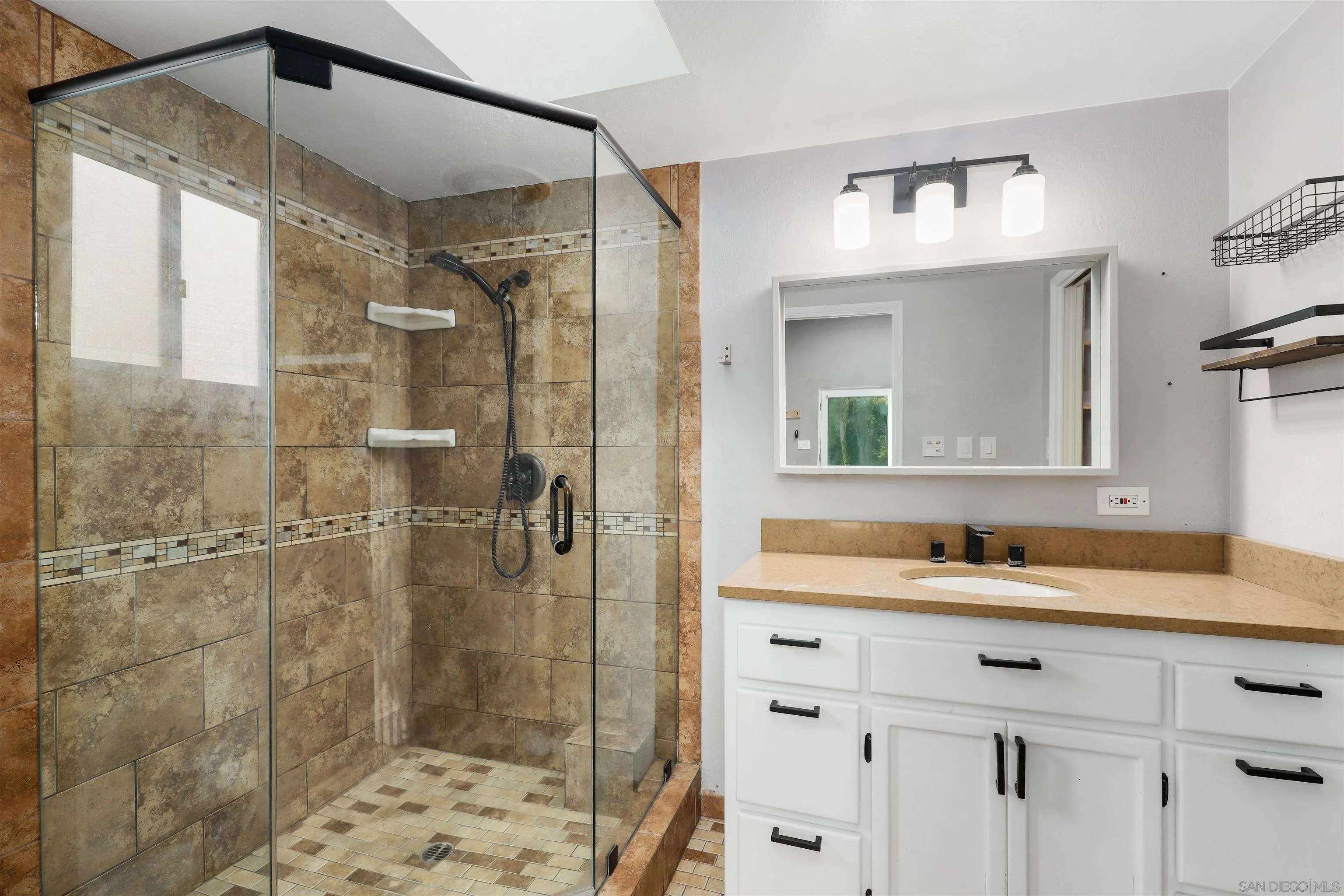 12256 Old Stone Road Poway, CA 92064 - Photo 20 of 31 a bathroom with a shower sink and mirror