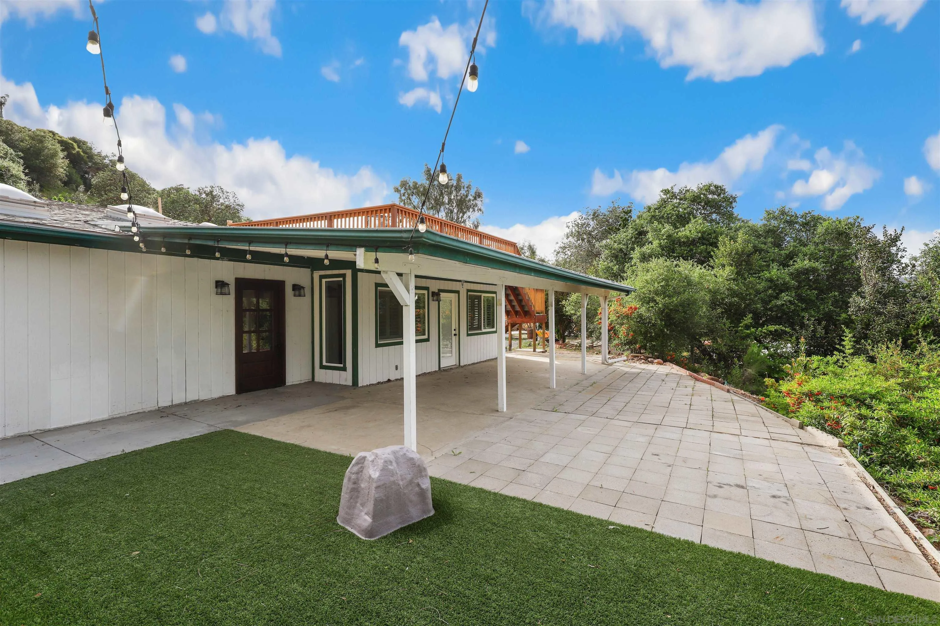 12256 Old Stone Road Poway, CA 92064 - Photo 4 of 31 a front view of a house with a garden