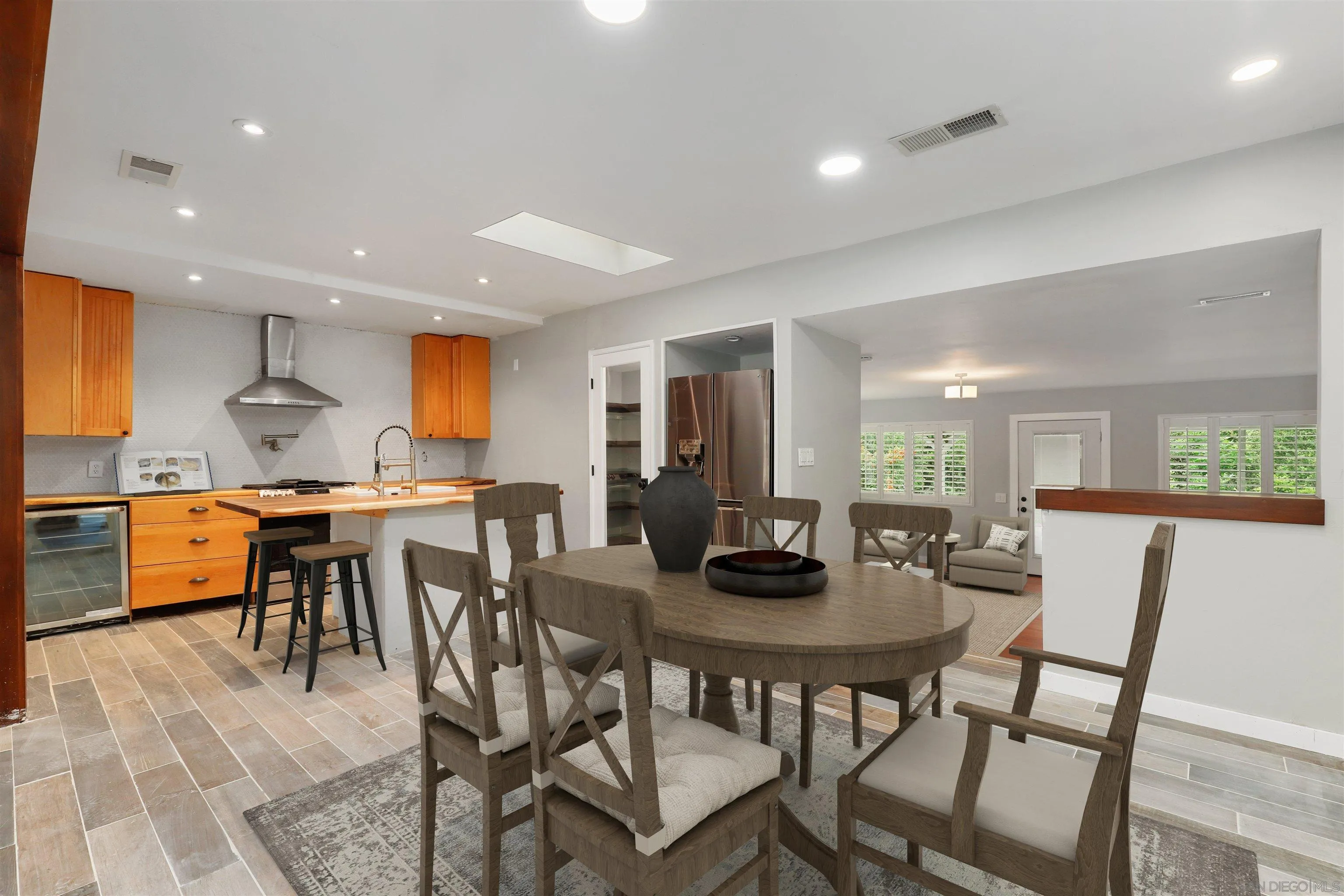 12256 Old Stone Road Poway, CA 92064 - Photo 10 of 31 a view of a dining room with furniture and wooden floor