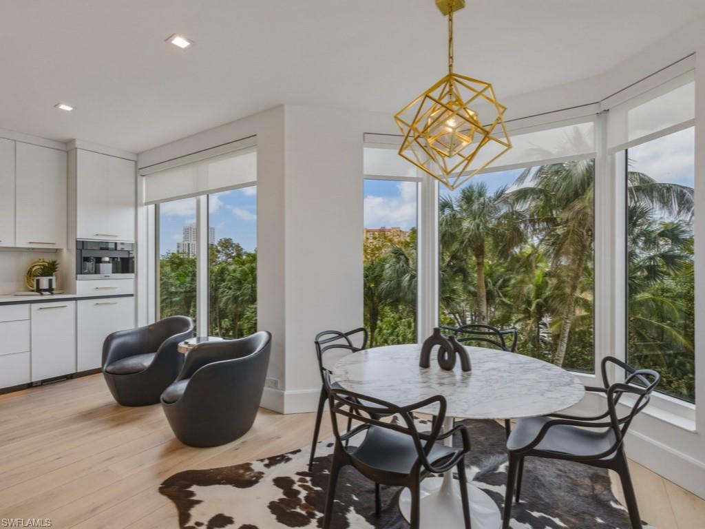 8787 Bay Colony Drive, Unit 306 Naples, FL 34108 - Photo 15 of 40 a view of a dining room with furniture window and outside view