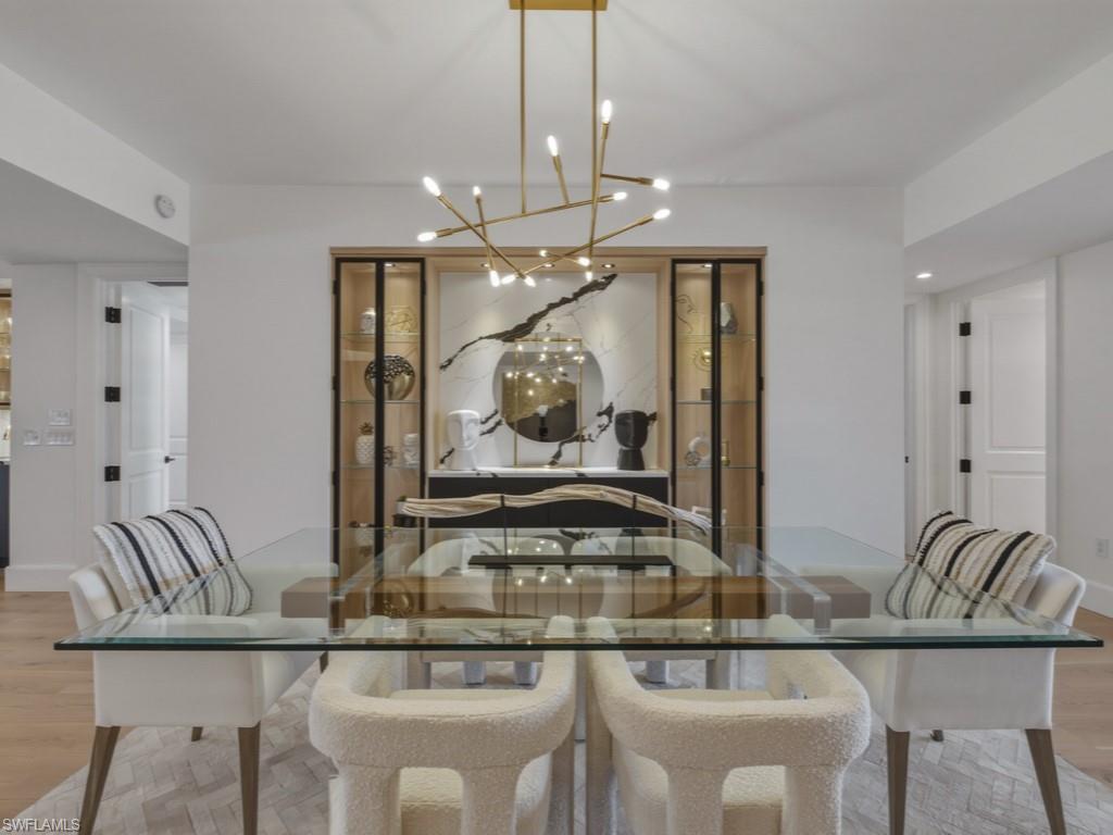 8787 Bay Colony Drive, Unit 306 Naples, FL 34108 - Photo 18 of 40 a kitchen with a table and chairs in it
