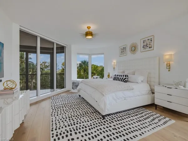 a bedroom with a bed and a large window