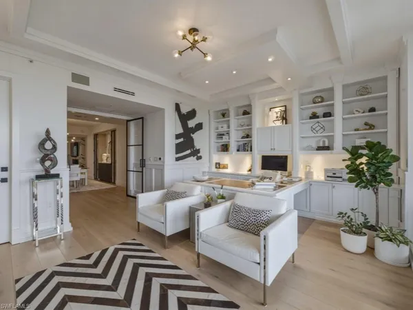 a living room with furniture and view of kitchen