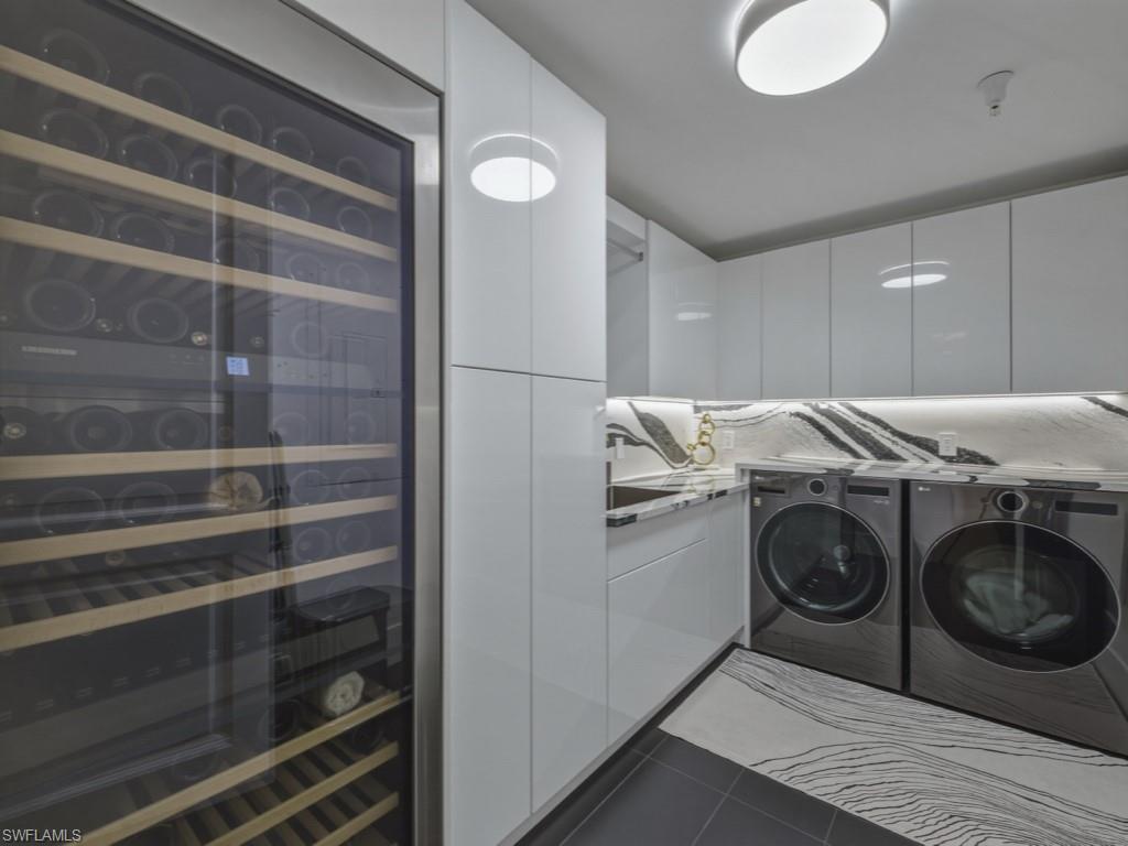 8787 Bay Colony Drive, Unit 306 Naples, FL 34108 - Photo 31 of 40 a utility room with washer and dryer