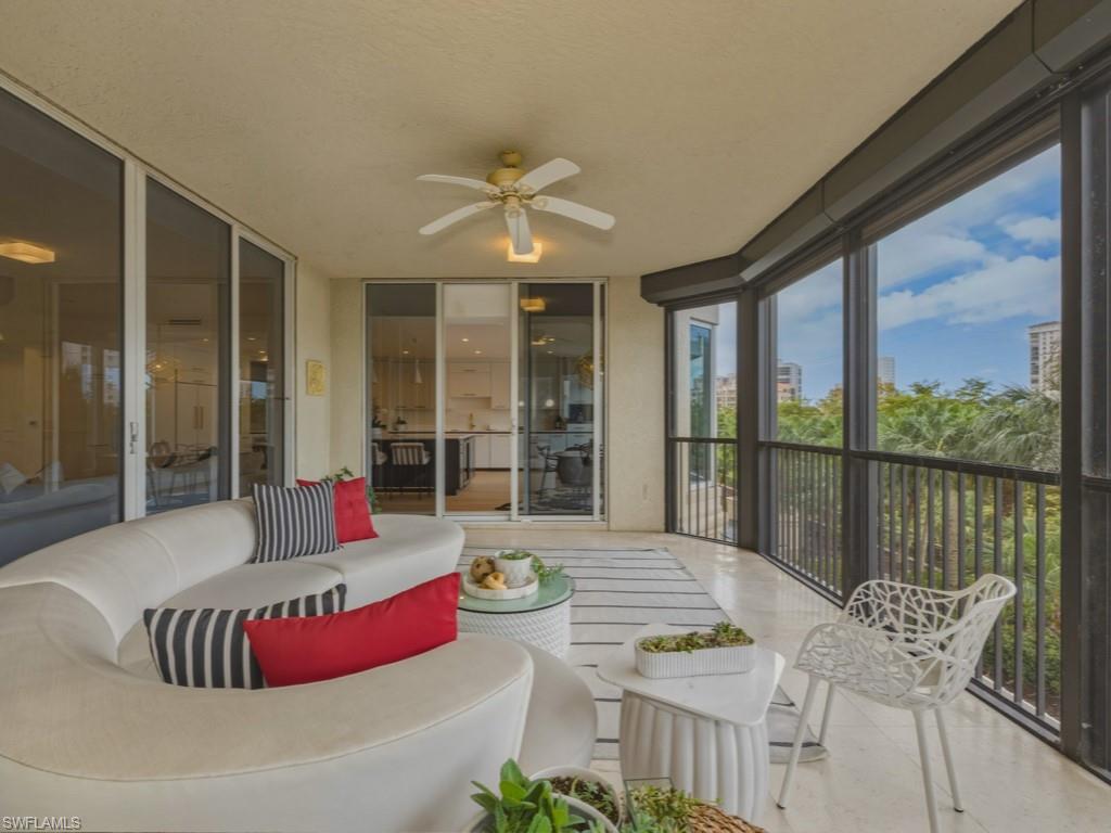 8787 Bay Colony Drive, Unit 306 Naples, FL 34108 - Photo 32 of 40 a living room with furniture and a large window
