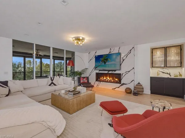 a bedroom with furniture and a large window