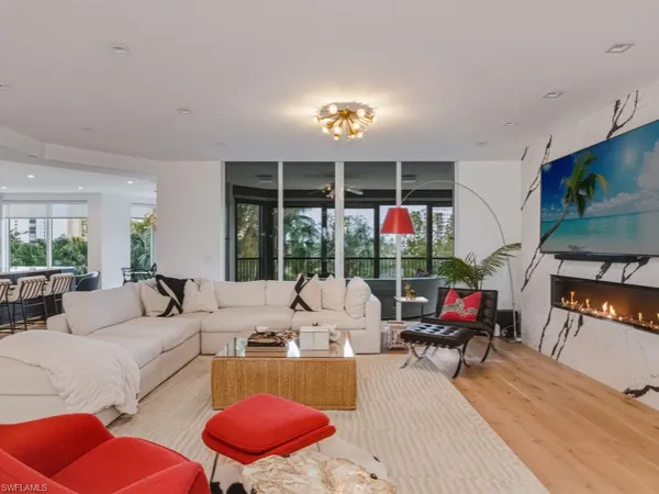 a living room with furniture a fireplace and a flat screen tv