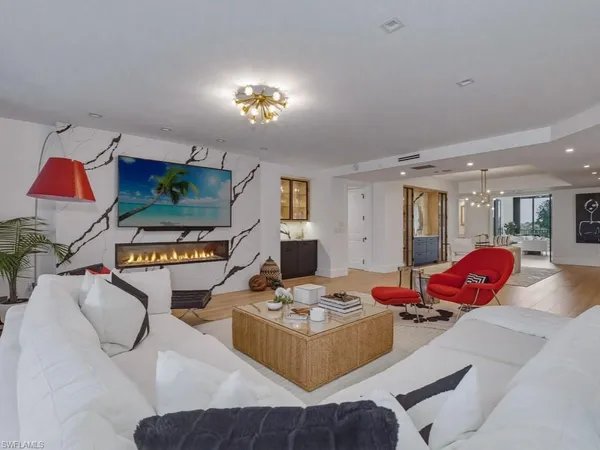 a living room with furniture and painting on the wall