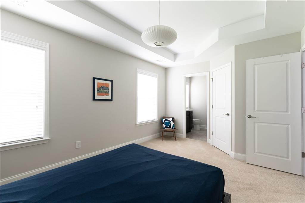 1940 Townsend Court, Unit 15 Atlanta, GA 30329 - Photo 19 of 36 a bedroom with a bed and a large window