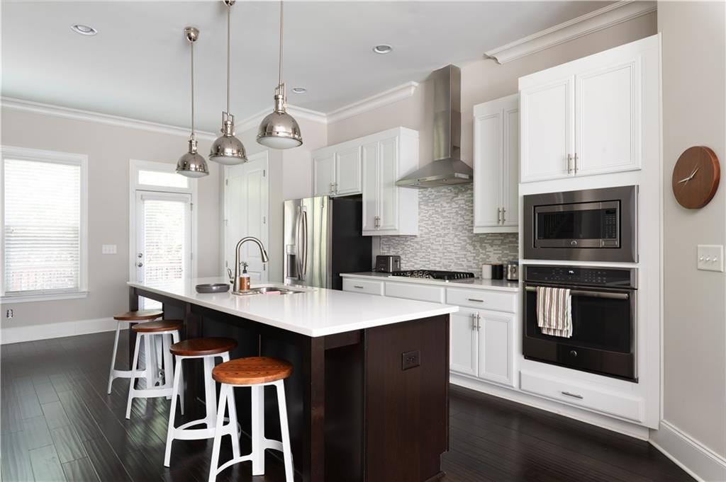 1940 Townsend Court, Unit 15 Atlanta, GA 30329 - Photo 2 of 36 a kitchen with a sink a stove and cabinets