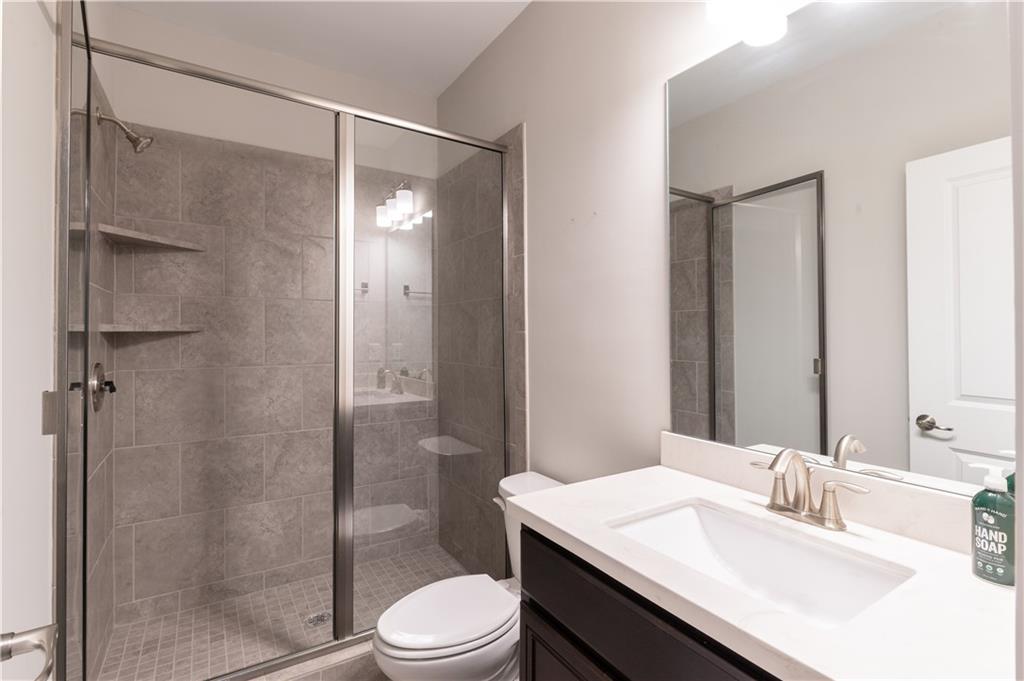 1940 Townsend Court, Unit 15 Atlanta, GA 30329 - Photo 24 of 36 a bathroom with a sink toilet and shower