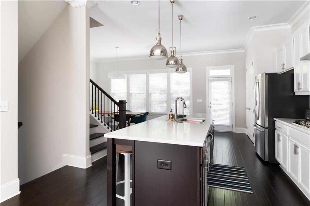1940 Townsend Court, Unit 15 Atlanta, GA 30329 - Photo 4 of 36 a kitchen with kitchen island a sink appliances and a counter top space