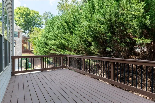 a balcony with wooden floor and fence