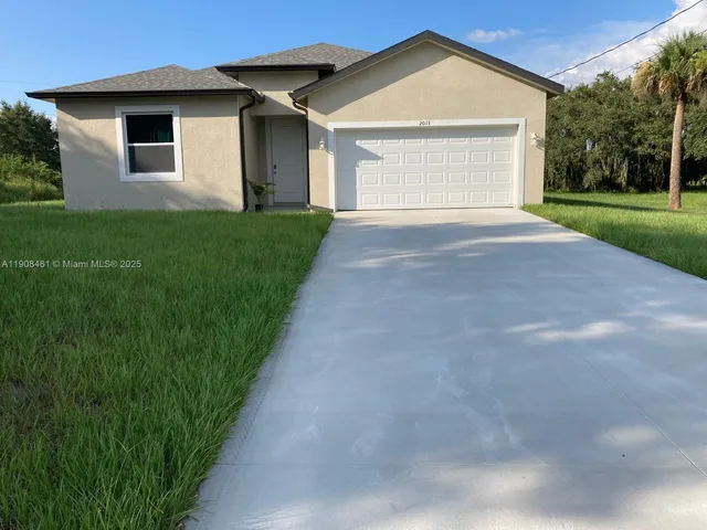 a view of a house with a yard and garage