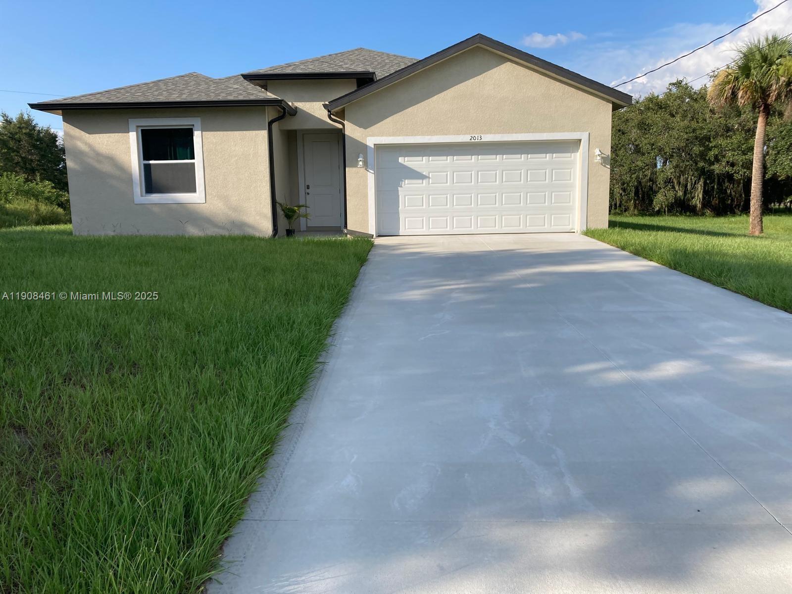 a view of a house with a yard and garage