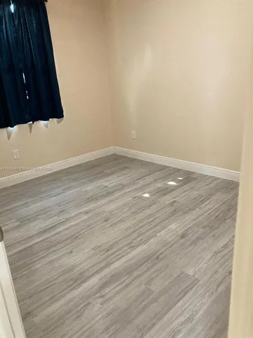 an empty room with wooden floor