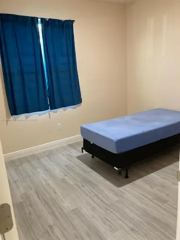 a bedroom with a bed and wooden cabinets