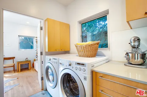 a view of kitchen filled with furniture and wooden floor