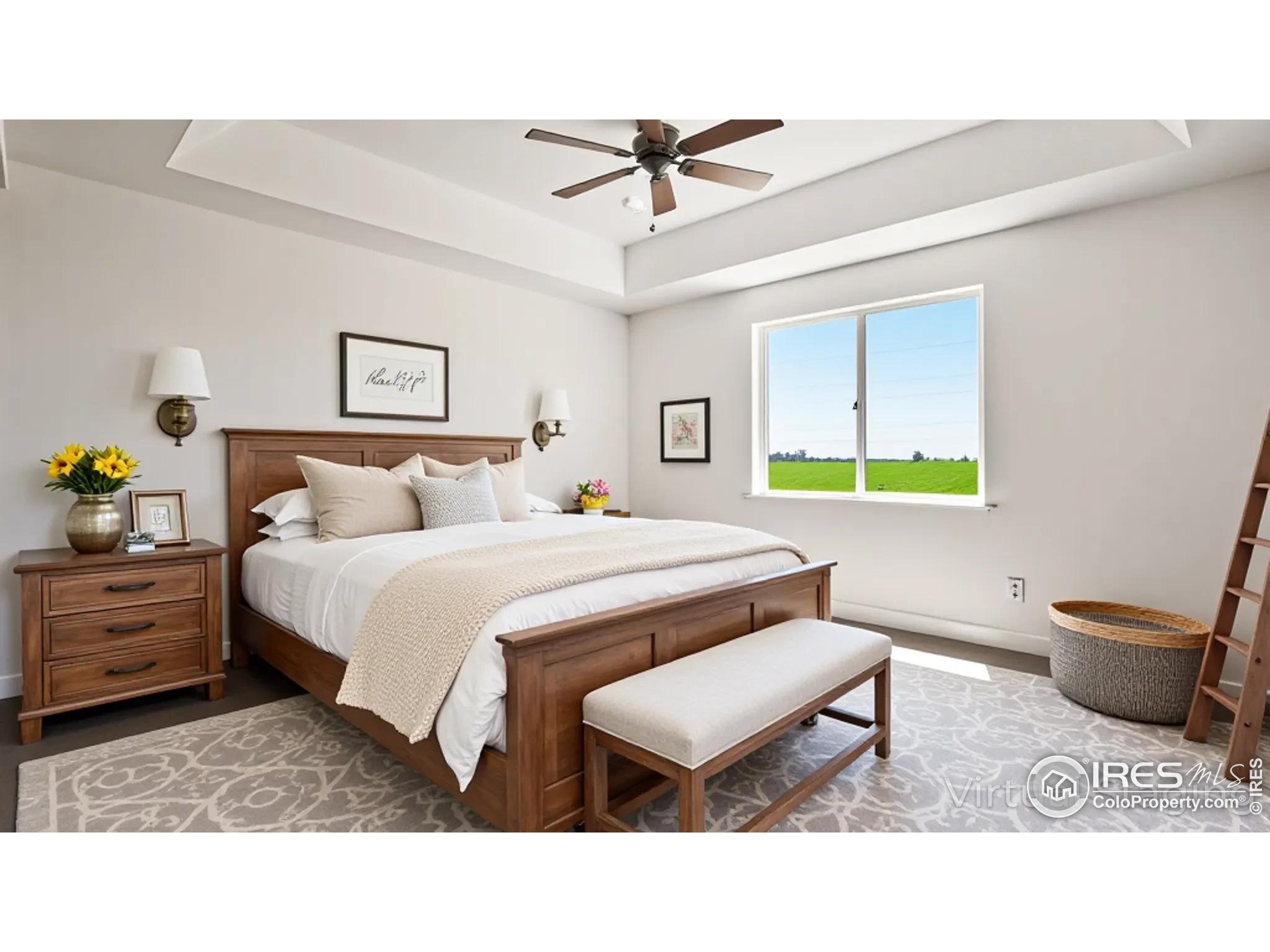 448 Cache Avenue Fort Morgan, CO 80701 - Photo 13 of 44 a bedroom with a bed and a chandelier