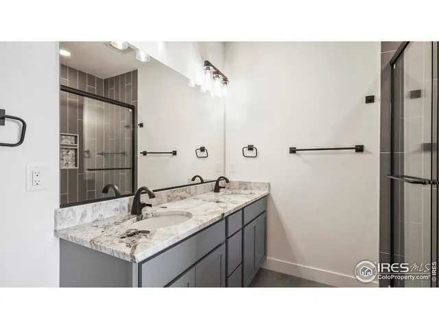 a bathroom with a shower and a sink