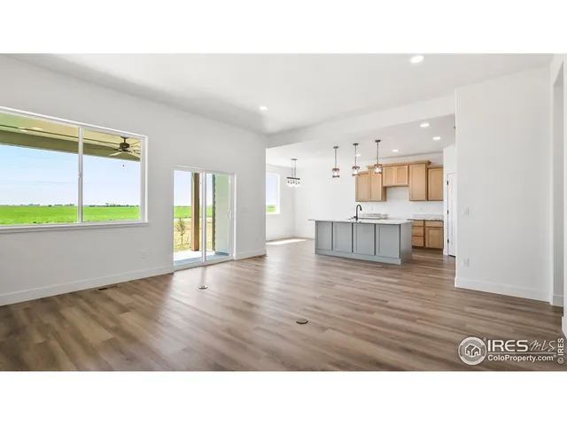 a living room with kitchen island furniture and a wooden floor